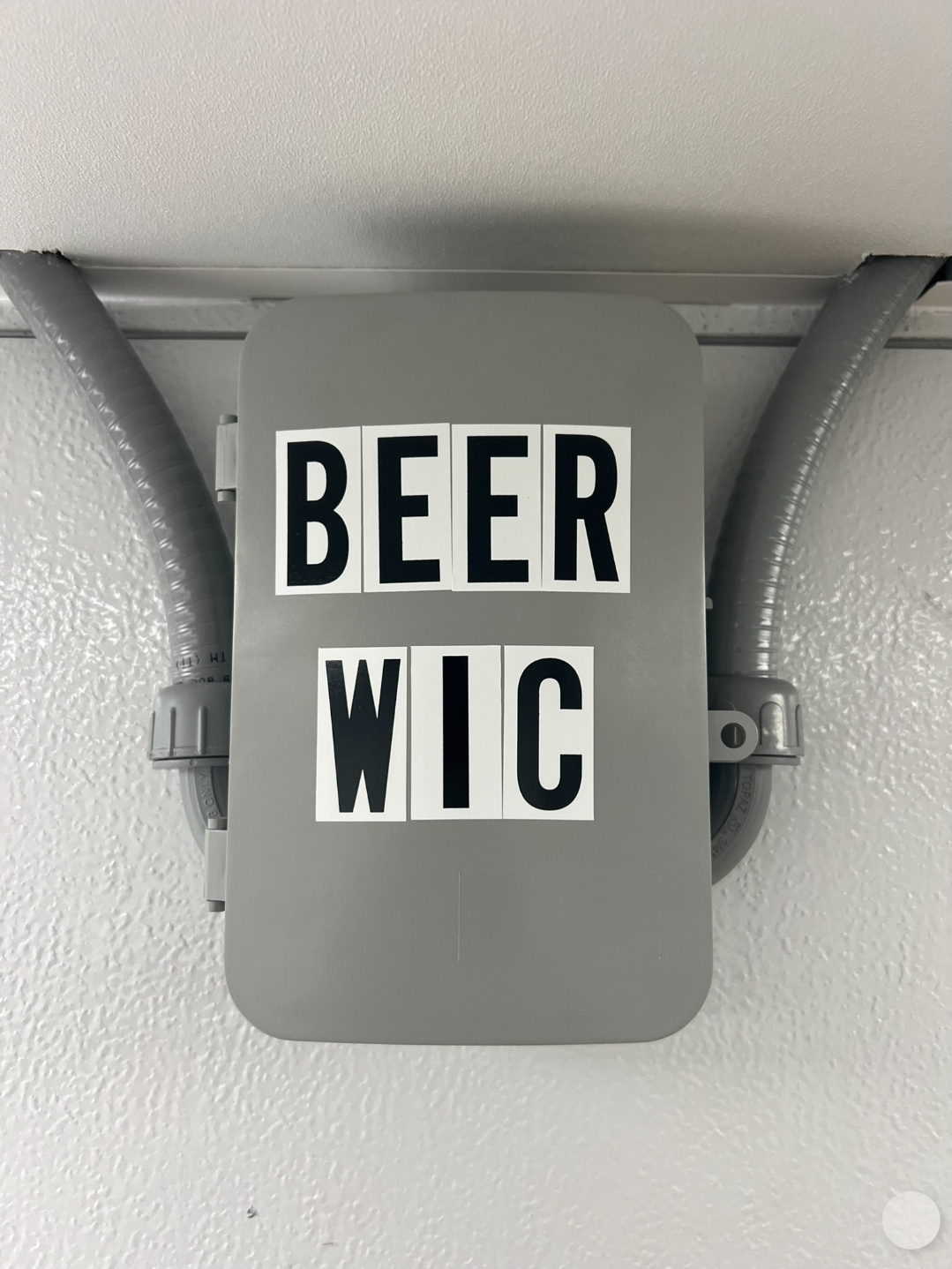 Commercial walk-in cooler installation with Beer WIC signage