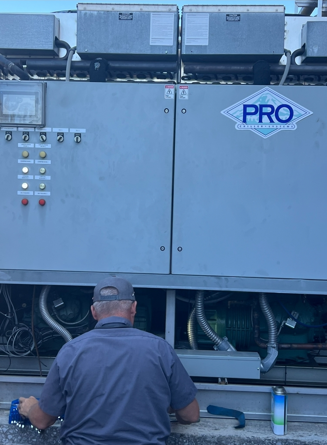 Technician servicing large commercial refrigeration equipment