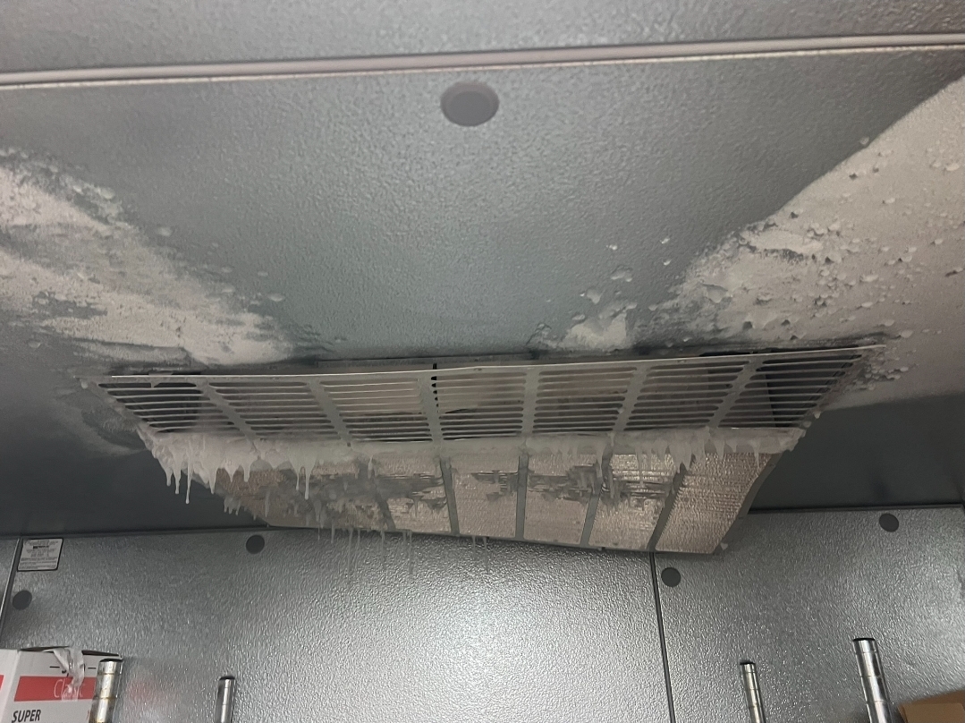 Close-up view of evaporator coils with heavy ice formation