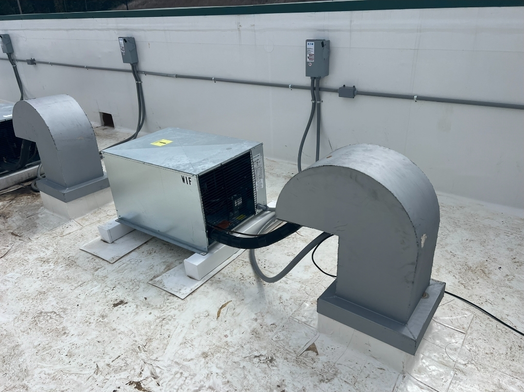 Professional rooftop HVAC system installation with condensing units