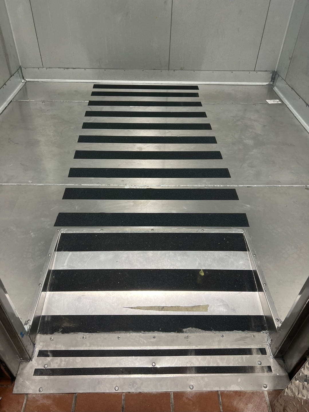 Walk-in cooler floor with anti-slip safety strips