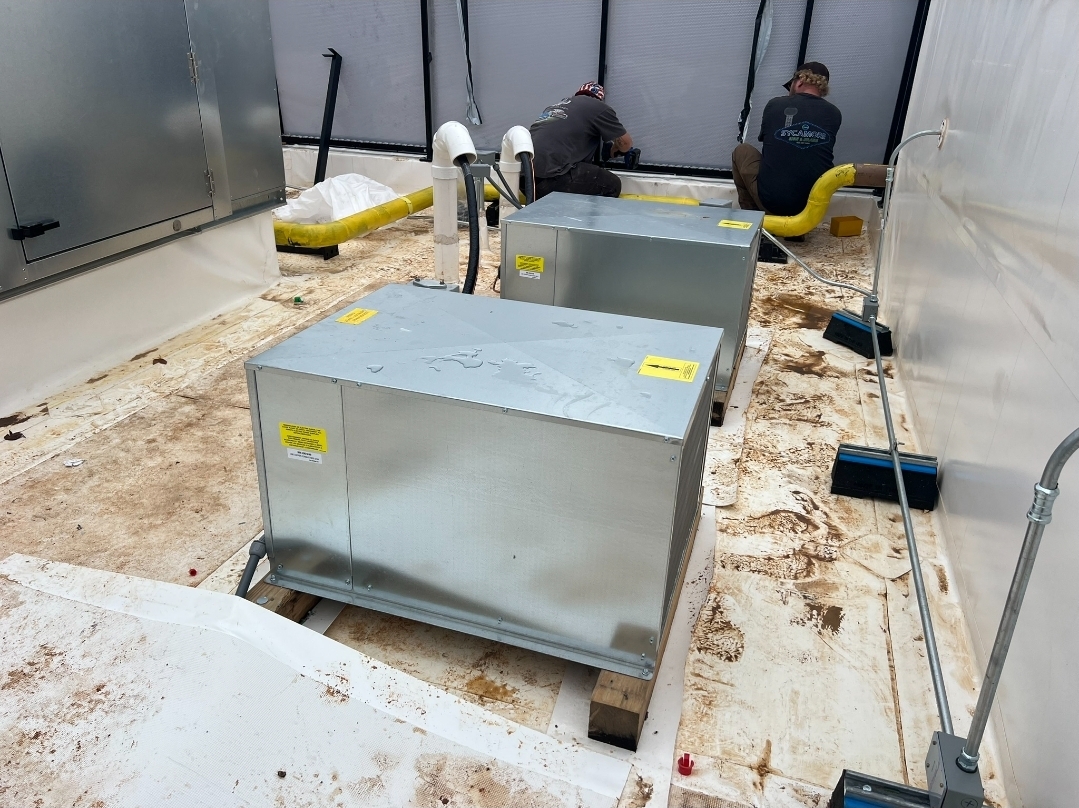 Walk-in cooler installation in progress with technicians